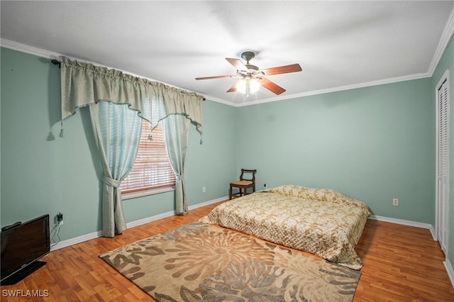 1263 Caloosa Dr, Fort Myers, FL 33901 - bedroom with wood finished floors, baseboards, ornamental molding, a closet, and a ceiling fan