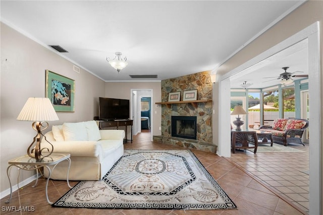 1263 Caloosa Dr, Fort Myers, FL 33901 - tiled living room with ornamental molding, a stone fireplace, ceiling fan, and baseboards