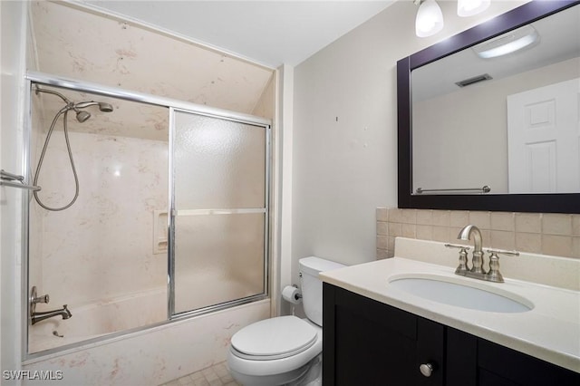 1263 Caloosa Dr, Fort Myers, FL 33901 - bathroom with vanity, toilet, tasteful backsplash, and combined bath / shower with glass door