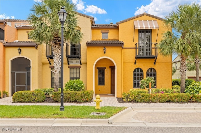 11919 Palba Way Unit 6706, Fort Myers, FL 33912 - mediterranean / spanish-style house with a balcony, a tile roof, and stucco siding