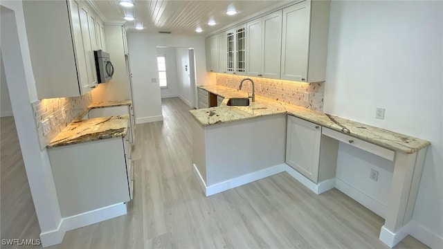 718 Reef Point Cir, Naples, FL 34108 - kitchen with stainless steel microwave, baseboards, glass insert cabinets, decorative backsplash, and recessed lighting