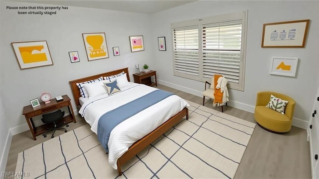 718 Reef Point Cir, Naples, FL 34108 - bedroom with baseboards and light wood-style floors