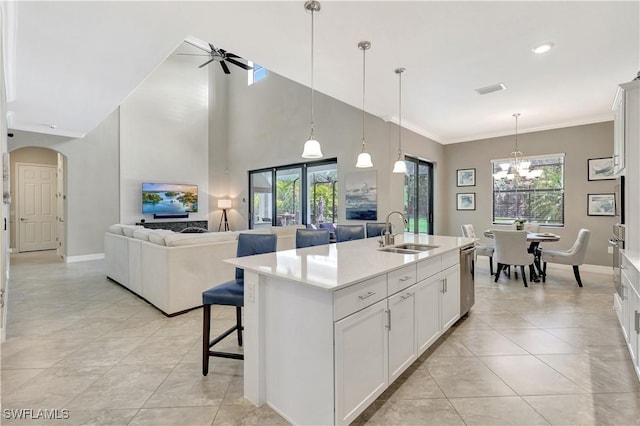 2102 Antigua Ln, Naples, FL 34120 - kitchen with a sink, a ceiling fan, open floor plan, a chandelier, and arched walkways