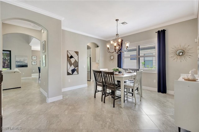2102 Antigua Ln, Naples, FL 34120 - dining space featuring arched walkways, a chandelier, crown molding, and baseboards