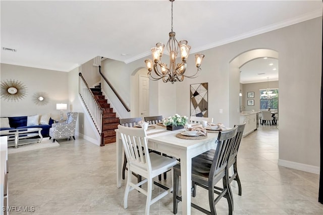 2102 Antigua Ln, Naples, FL 34120 - dining area featuring arched walkways, a chandelier, crown molding, baseboards, and stairway