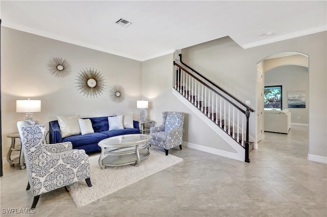 2102 Antigua Ln, Naples, FL 34120 - living room with ornamental molding, arched walkways, stairway, baseboards, and tile patterned floors