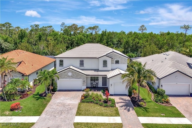 2102 Antigua Ln, Naples, FL 34120 - view of front of property with decorative driveway, a front yard, stucco siding, a tile roof, and a garage