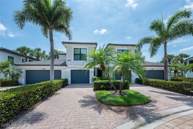 view of front facade featuring decorative driveway and stucco siding