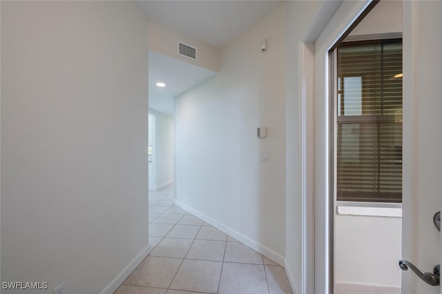 corridor with light tile patterned floors, baseboards, and recessed lighting