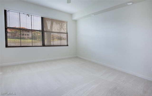 spare room with carpet and baseboards