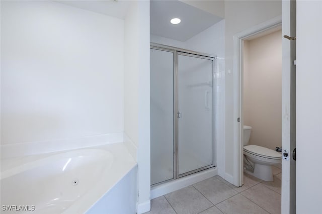 bathroom featuring a shower stall, tile patterned flooring, toilet, and a bath