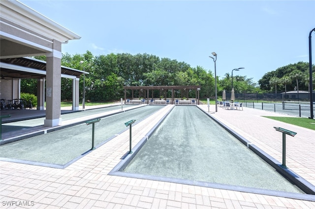 surrounding community featuring a game area and fence