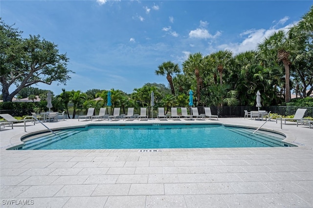 community pool featuring a patio area and fence