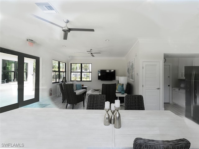 dining room featuring ornamental molding, wood finished floors, and ceiling fan