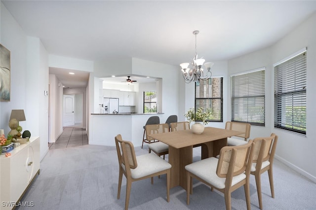 dining area with light carpet, a chandelier, healthy amount of natural light, recessed lighting, and baseboards