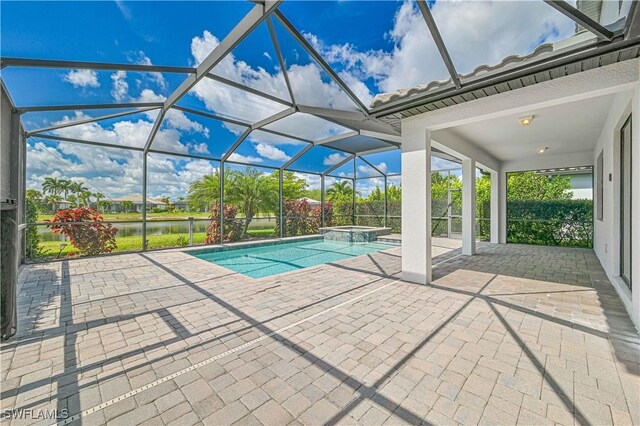 11937 Silver Cobblestone Way, Fort Myers, FL 33913 - view of pool with a patio area, a water view, a pool with connected hot tub, and a lanai