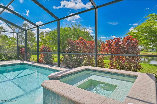 11937 Silver Cobblestone Way, Fort Myers, FL 33913 - swimming pool featuring an in-ground hot tub, glass enclosure, and a water view