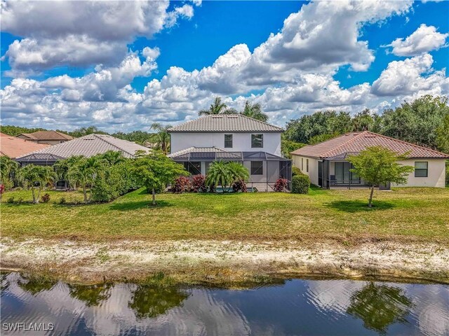 11937 Silver Cobblestone Way, Fort Myers, FL 33913 - rear view of house with a tiled roof, a water view, a lawn, a lanai, and stucco siding