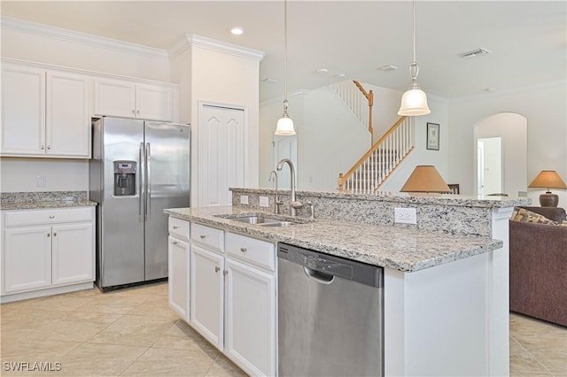 11937 Silver Cobblestone Way, Fort Myers, FL 33913 - kitchen with stainless steel appliances, a sink, open floor plan, crown molding, and white cabinets