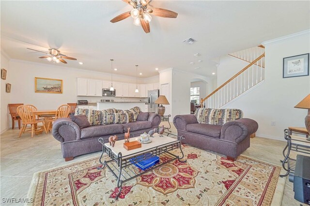 11937 Silver Cobblestone Way, Fort Myers, FL 33913 - living room featuring a ceiling fan, arched walkways, stairway, ornamental molding, and baseboards