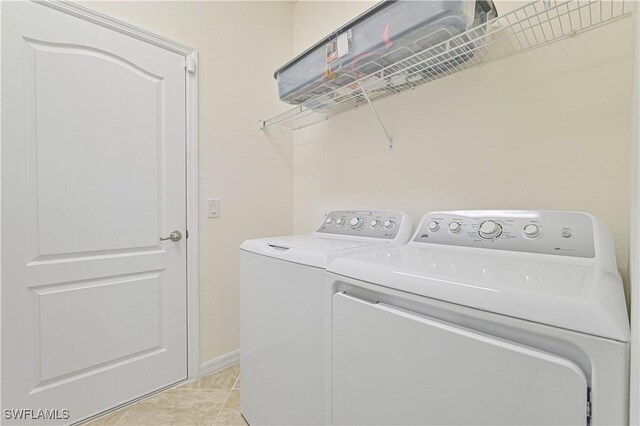11937 Silver Cobblestone Way, Fort Myers, FL 33913 - laundry area featuring washer and dryer, baseboards, and light tile patterned flooring