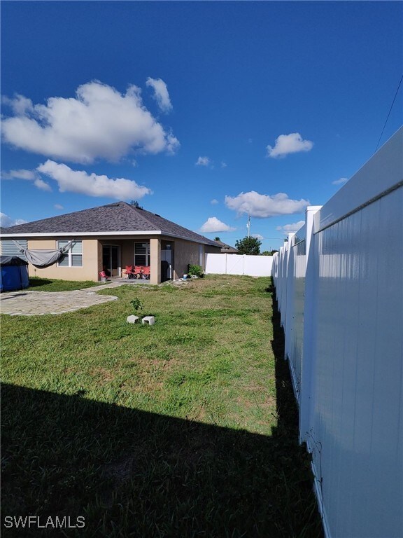 2709 SW 4th Pl, Cape Coral, FL 33914 - view of yard with a patio area