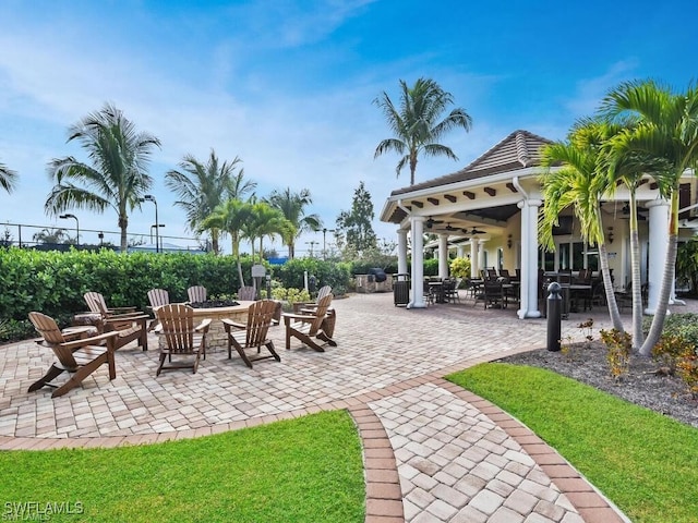 10947 Clarendon St, Fort Myers, FL 33913 - view of patio / terrace with ceiling fan, an outdoor fire pit, fence, and outdoor dining area