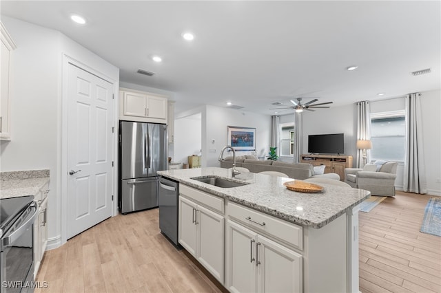 16523 Crescent Beach Way, Bonita Springs, FL 34135 - kitchen featuring appliances with stainless steel finishes, a sink, a ceiling fan, light wood-style flooring, and recessed lighting