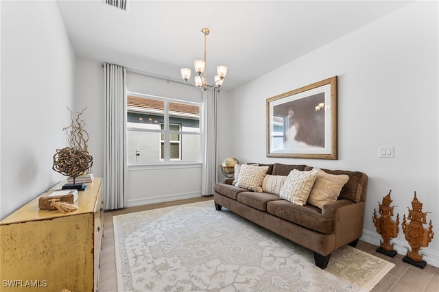 16523 Crescent Beach Way, Bonita Springs, FL 34135 - living area featuring light wood-style flooring, a chandelier, and baseboards