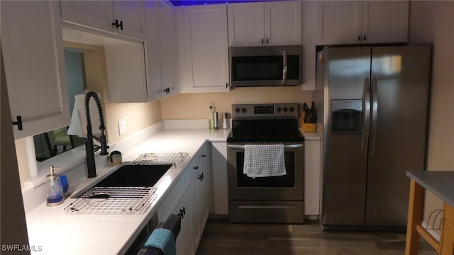 17156 Ravens Roost Unit 7, Fort Myers, FL 33908 - kitchen with appliances with stainless steel finishes, dark wood-type flooring, and light countertops