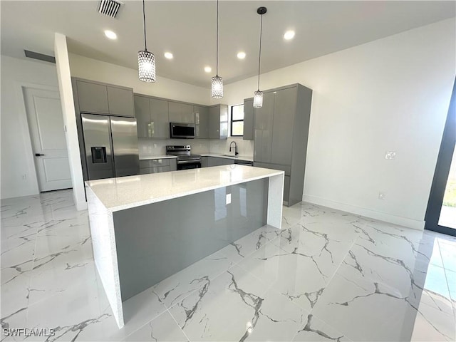 2607 E 18th St, Lehigh Acres, FL 33972 - kitchen featuring appliances with stainless steel finishes, gray cabinetry, a sink, recessed lighting, and light marble finish floors