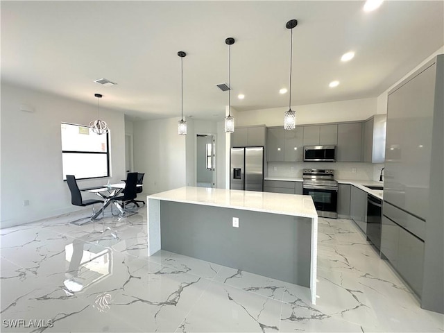 2607 E 18th St, Lehigh Acres, FL 33972 - kitchen with gray cabinetry, appliances with stainless steel finishes, modern cabinets, a center island, and recessed lighting
