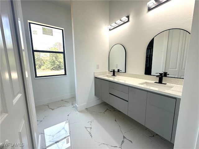 2607 E 18th St, Lehigh Acres, FL 33972 - full bath featuring marble finish floors, double vanity, and baseboards