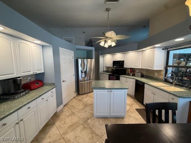 1200 Elaine Ave N, Lehigh Acres, FL 33971 - kitchen with black appliances, a sink, decorative backsplash, light tile patterned flooring, and white cabinets