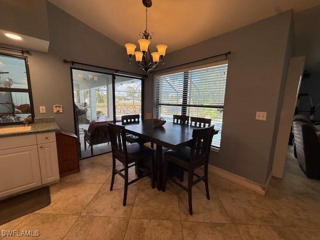 1200 Elaine Ave N, Lehigh Acres, FL 33971 - dining area with a chandelier, lofted ceiling, and light tile patterned flooring