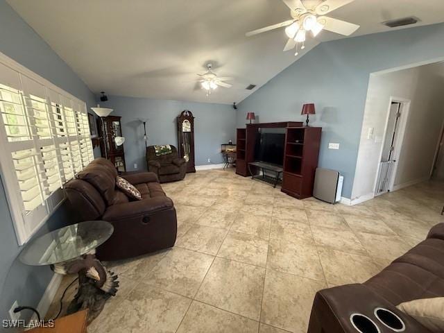 1200 Elaine Ave N, Lehigh Acres, FL 33971 - living room featuring lofted ceiling, ceiling fan, light tile patterned floors, and baseboards