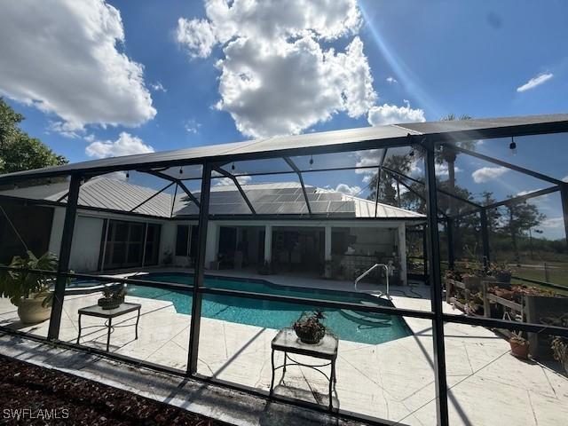1200 Elaine Ave N, Lehigh Acres, FL 33971 - swimming pool featuring a lanai and a patio area