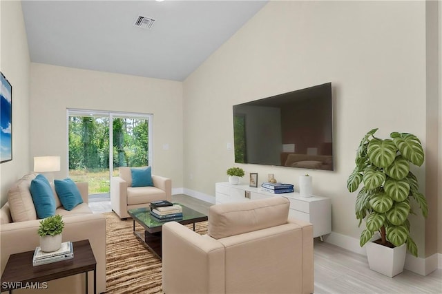 876 Apartment St E, Lehigh Acres, FL 33974 - living room with baseboards, light wood-style floors, and lofted ceiling