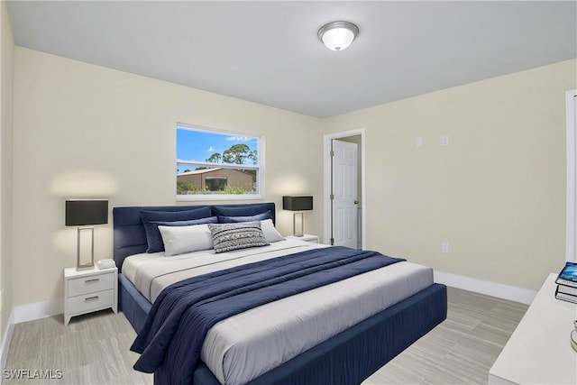 876 Apartment St E, Lehigh Acres, FL 33974 - bedroom with baseboards and light wood-type flooring