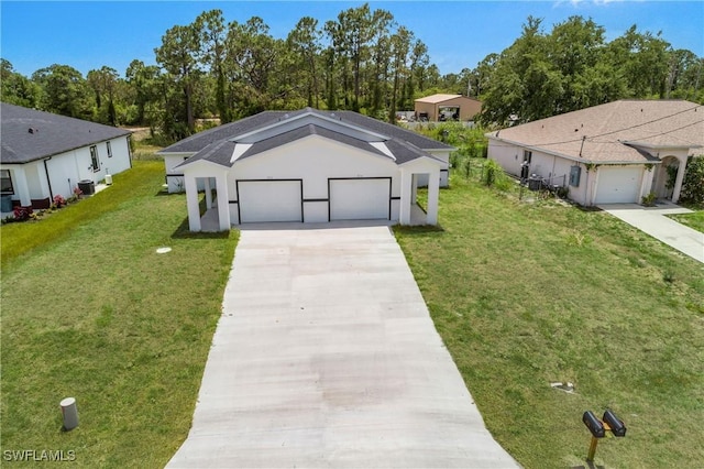 876 Apartment St E, Lehigh Acres, FL 33974 - view of front of house featuring a front yard, concrete driveway, central AC, and stucco siding