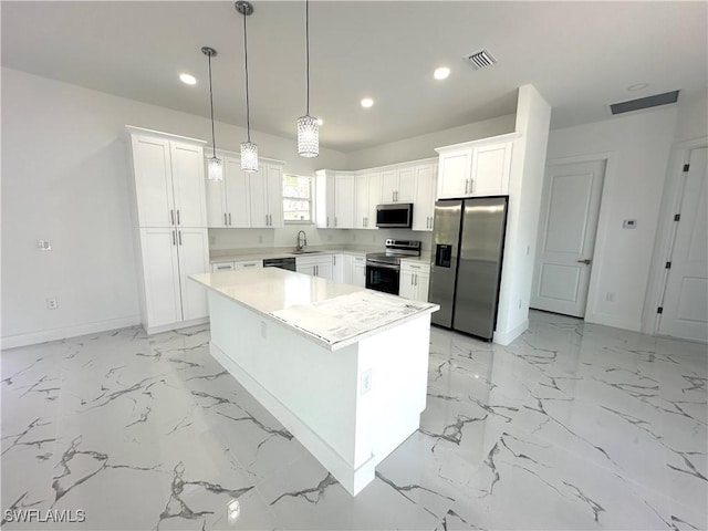 kitchen with stainless steel appliances, a sink, baseboards, recessed lighting, and white cabinetry