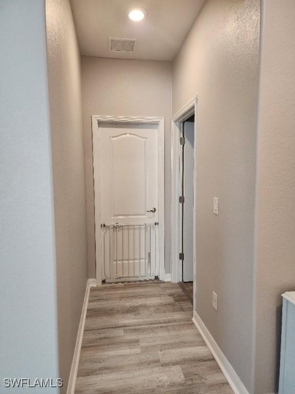16006 Mistflower Dr, Alva, FL 33920 - hallway featuring wood finished floors and baseboards