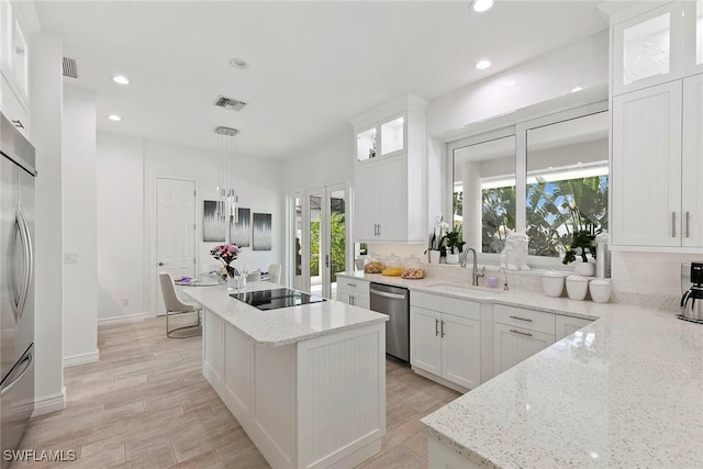 287 Meadowlark Ct, Marco Island, FL 34145 - kitchen featuring appliances with stainless steel finishes, plenty of natural light, a kitchen island, recessed lighting, and a sink