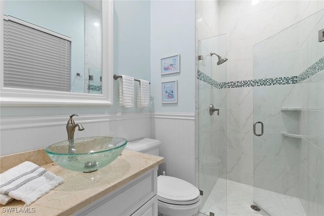 287 Meadowlark Ct, Marco Island, FL 34145 - bathroom with a stall shower, toilet, vanity, and a wainscoted wall