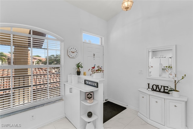 154 Newport Dr Unit 1307, Naples, FL 34114 - entrance foyer with light marble finish flooring and baseboards