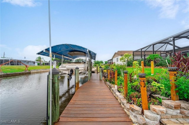134 Dartmouth Dr NW, Port Charlotte, FL 33952 - dock area featuring boat lift, a water view, and a lanai