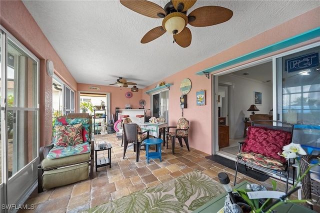 134 Dartmouth Dr NW, Port Charlotte, FL 33952 - sunroom with a textured ceiling and stone tile flooring