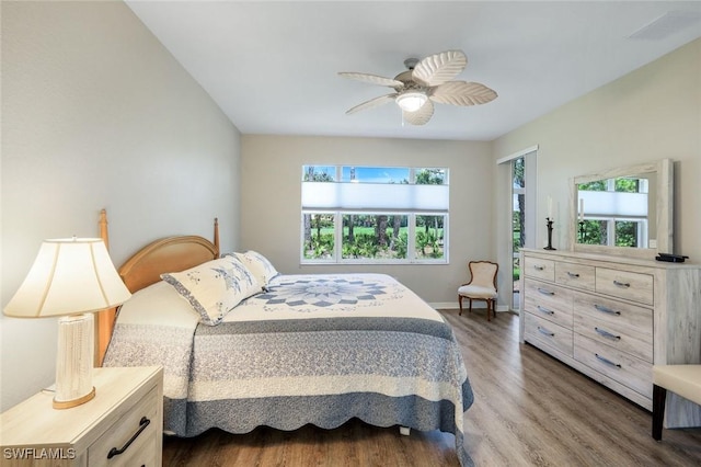20101 Seagrove St Unit 702, Estero, FL 33928 - bedroom with multiple windows, wood finished floors, baseboards, and ceiling fan