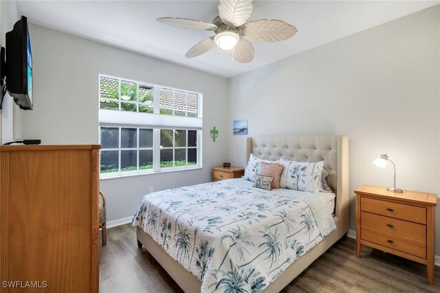 20101 Seagrove St Unit 702, Estero, FL 33928 - bedroom with wood finished floors, multiple windows, baseboards, and ceiling fan