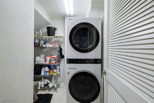 20101 Seagrove St Unit 702, Estero, FL 33928 - laundry room with stacked washer / dryer, light tile patterned floors, and a textured wall